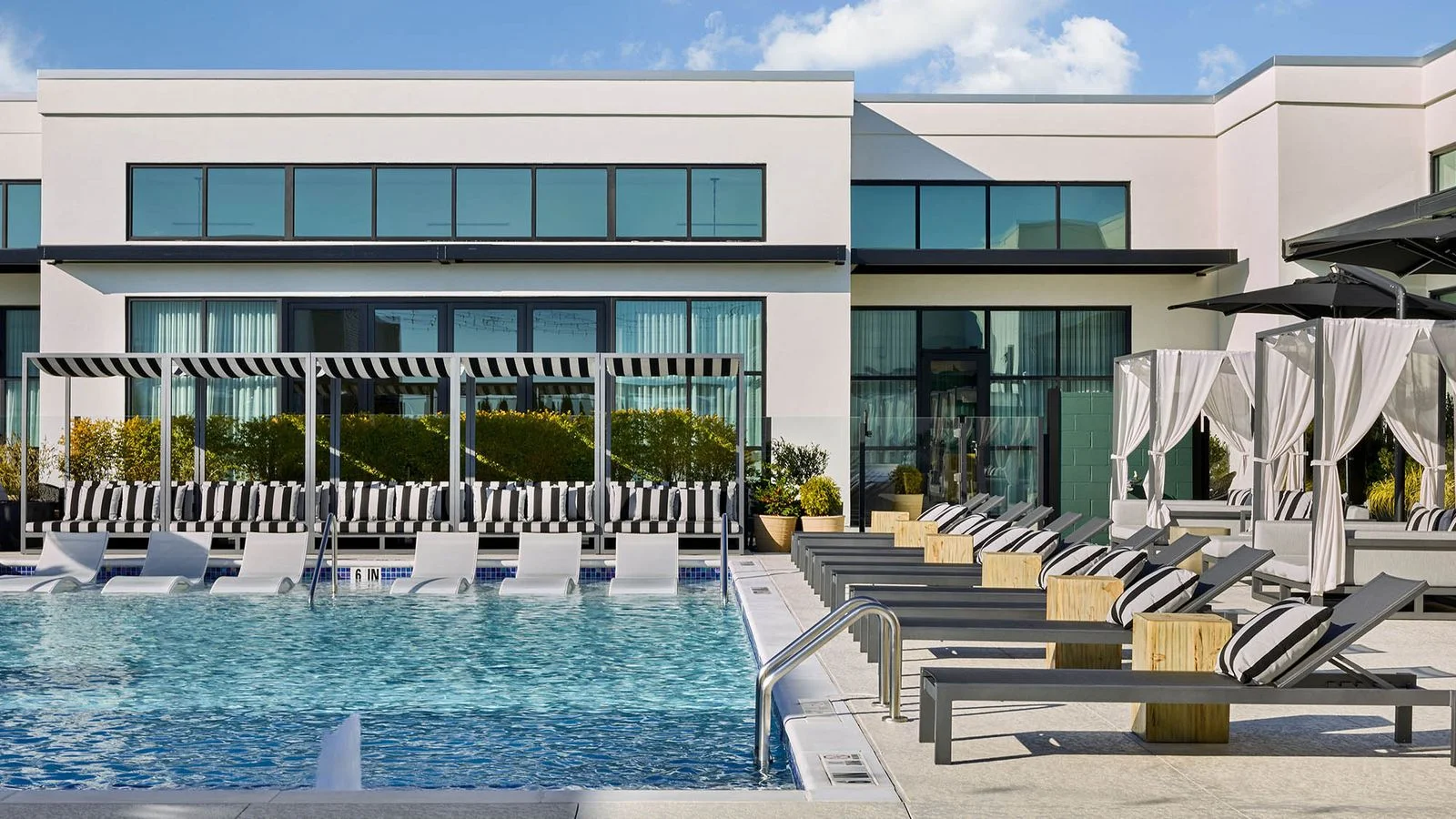 Image may contain Pool Water Swimming Pool Architecture Building House Housing Villa Chair Furniture and Plant