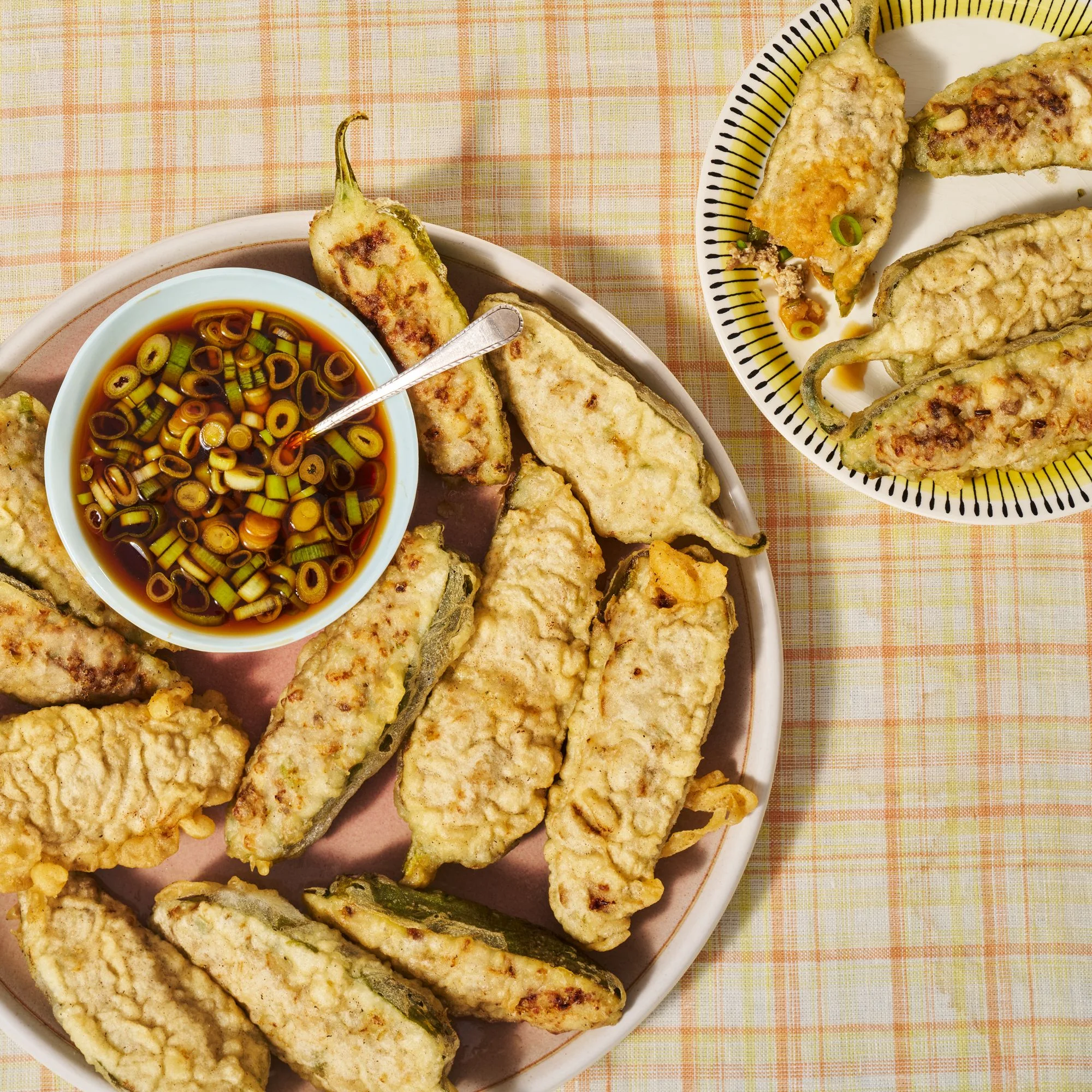 KoreanStyle FriedStuffed Peppers plated on a green plate and placed on a fabric surface