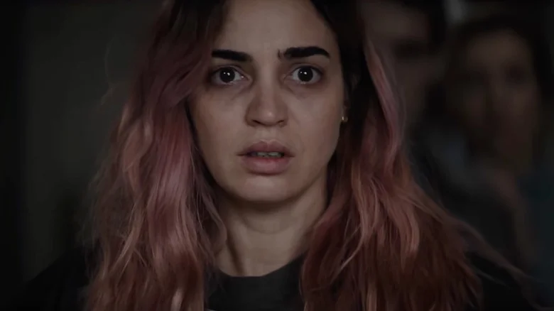 Souheila Yacoub as Allice with a look of terror on her face in Evil Dead Burn