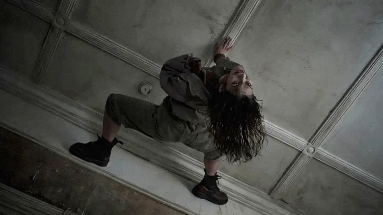 Luciane Buchanan as Thya as a Deadite on the ceiling in Evil Dead Burn