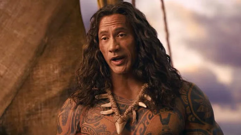 Dwayne Johnson as Maui standing on the boat with his jaw agape in Moana (2026)
