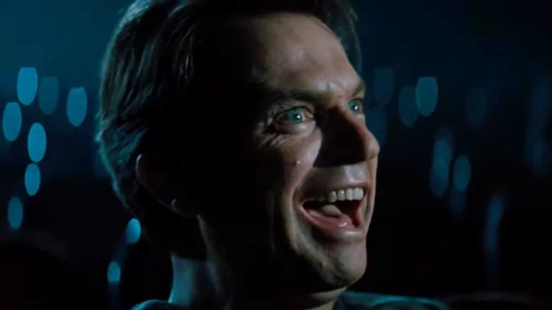 Sam Neill as John Trent laughing wildly in In the Mouth of Madness