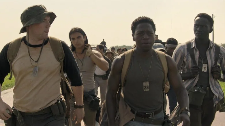 Cooper Hoffman as Ray, David Jonsson as Pete, and Tut Nyuot as Art walking together in The Long Walk