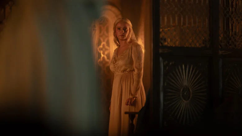 Phia Saban as Helaena Targaryen wearing a dressing gown in her bedroom in House of the Dragon