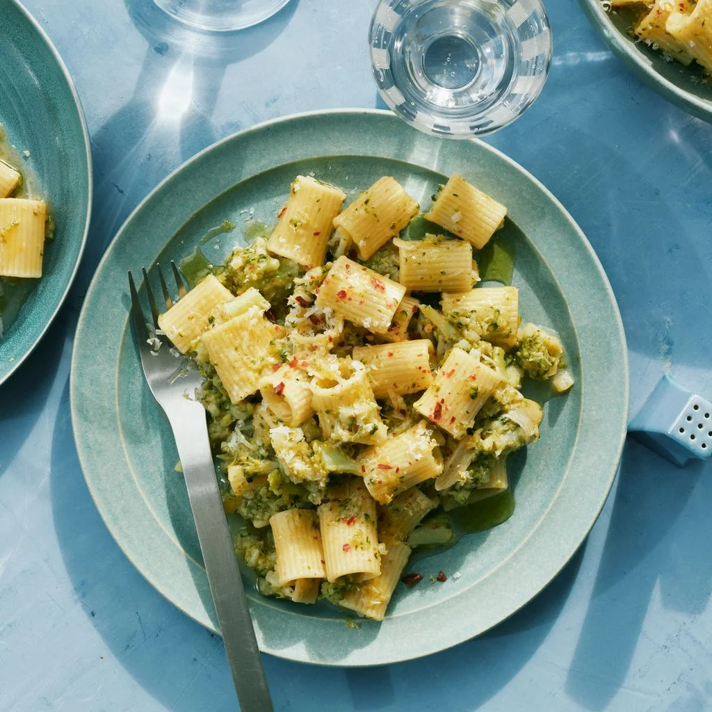 Three bowls of mezze rigatoni tossed broccoli stems in a lemonyanchovy sauce.