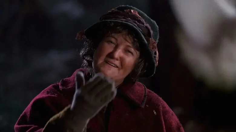 Brenda Fricker as Pigeon Lady wearing winter clothes and smiling in Home Alone 2: Lost in New York