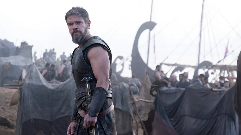 Matt Damon's Odysseus stands on a crowded beach in The Odyssey