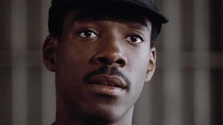 Eddie Murphy as Reggie Hammond wearing a baseball cap in 48 Hrs.