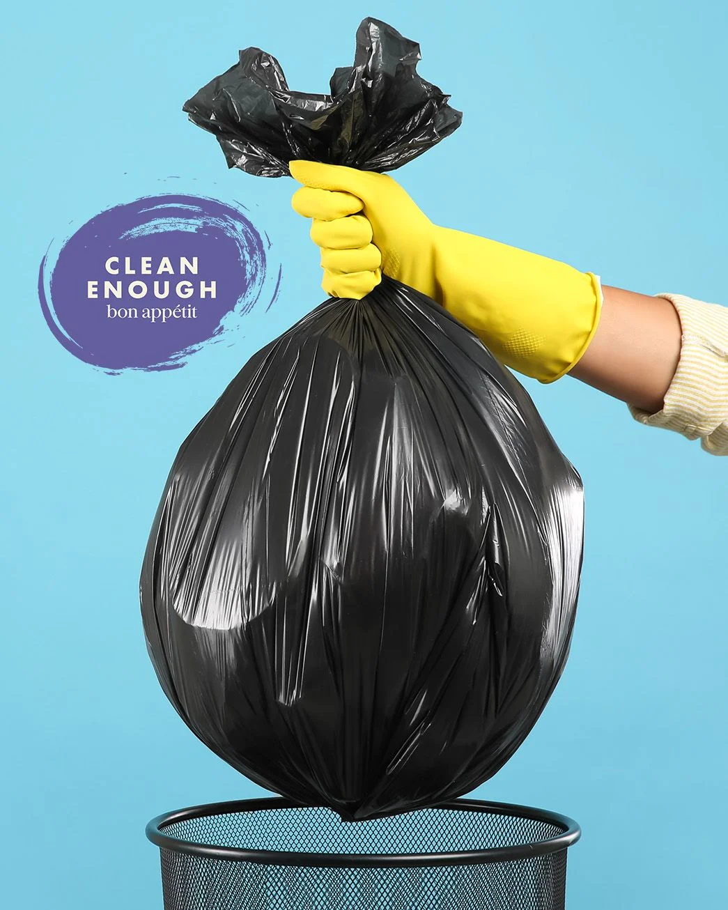 Image of hand with rubber glove lifting a trash bag out of a trash bin