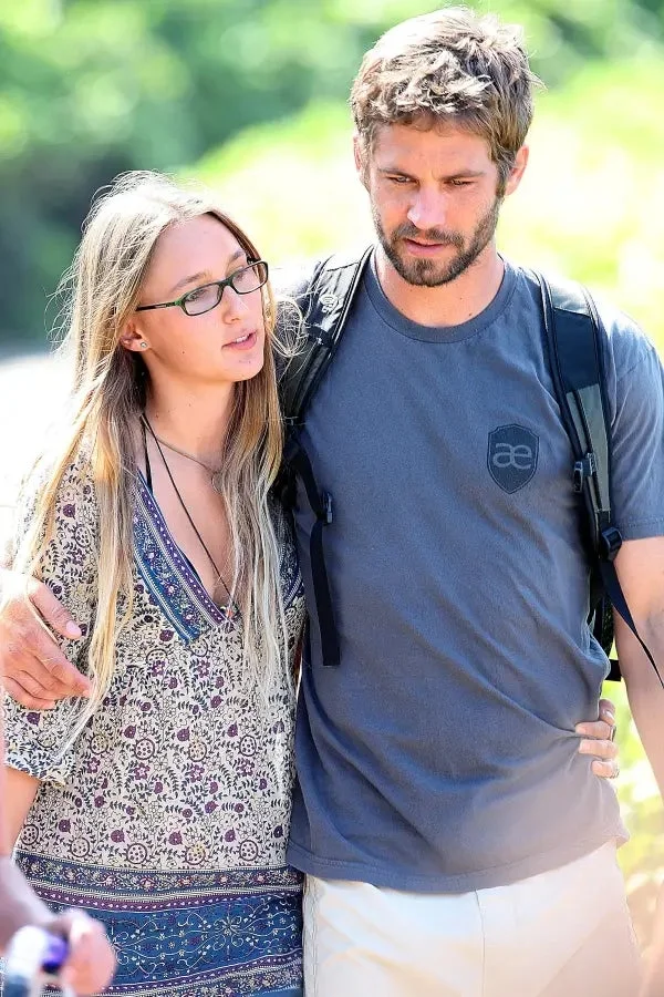 Paul Walker and Jasmine Pilchard-Gosnell hold each other while walking