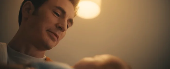 A person looks down warmly at a baby, creating a tender and intimate moment
