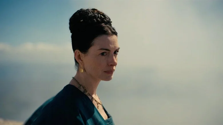 Anne Hathaway as Penelope standing outside in The Odyssey (2026)