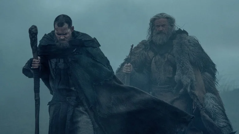 Bill Skarsgard as Little John and Hugh Jackman as Robin Hood walking in the fog in The Death of Robin Hood