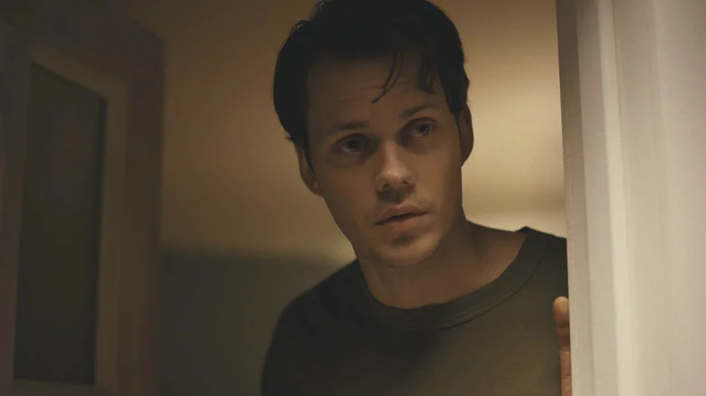 Bill Skarsgard as Keith standing in the doorway in Barbarian