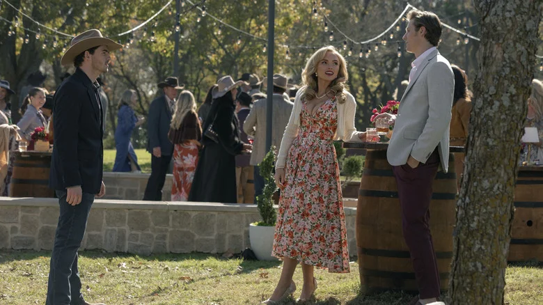 Finn Little's Carter Green stands opposite Natalie Alyn Lind's Oreana Lynn Jackson at an outdoor party in Dutton Ranch