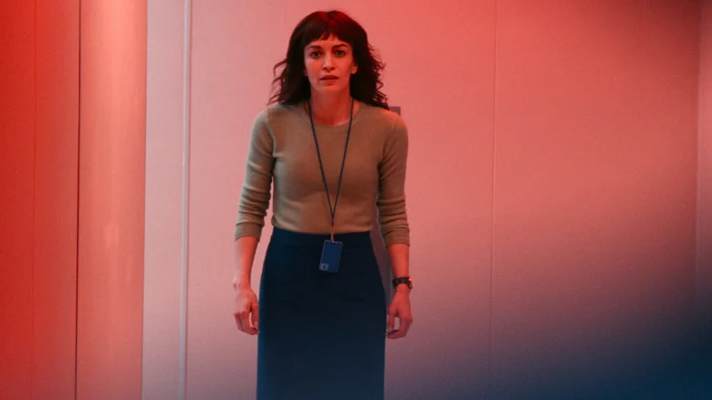 Helly looking hopeful while bathed in red light in Severance