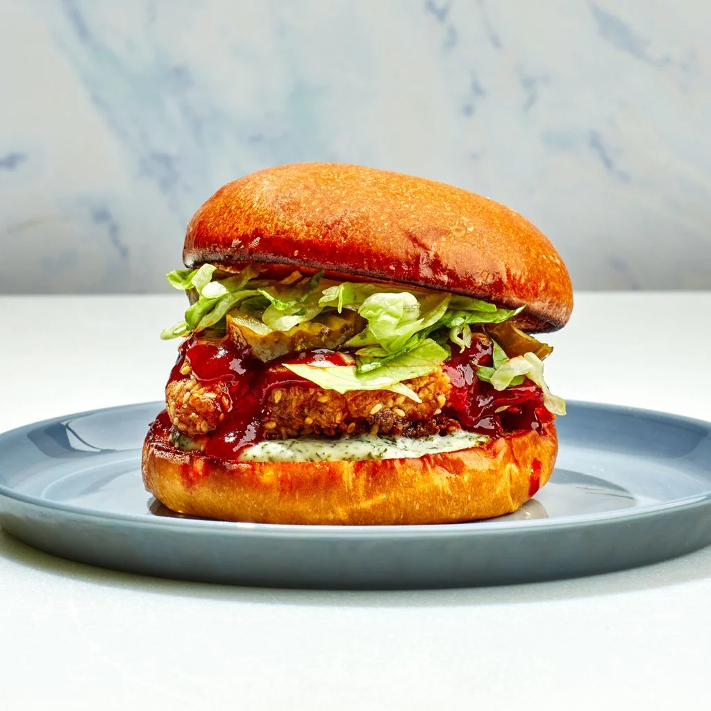 Fried Chicken Sandwich on a blue plate with a marbled background