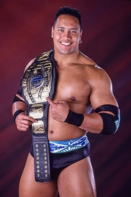 Dwayne "The Rock" Johnson posing with a WWE belt