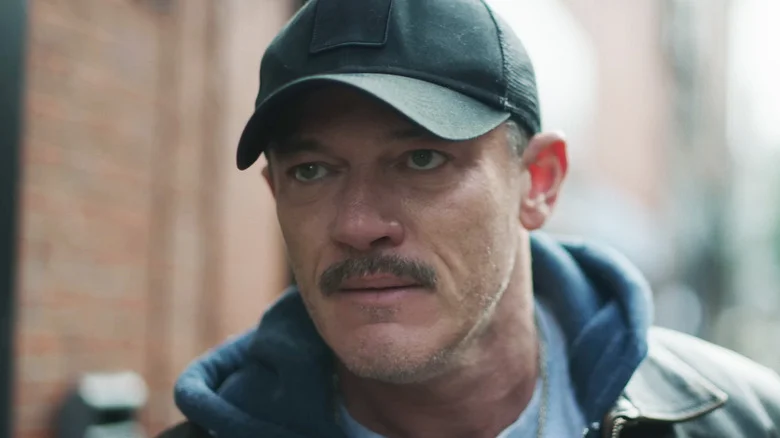 Luke Evans' Adam is seen in closeup as he stands on a street in 5lbs of Pressure