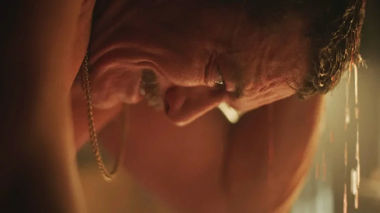 Luke Evans Adam looks down as water drips from his head in 5lbs of Pressure