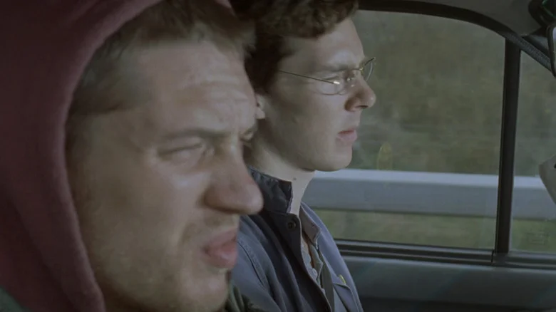 Tom Hardy's Stuart Clive Shorter screws his face up while he sits next to Benedict Cumberbatch's Alexander Masters in Stuart A Life Backwards