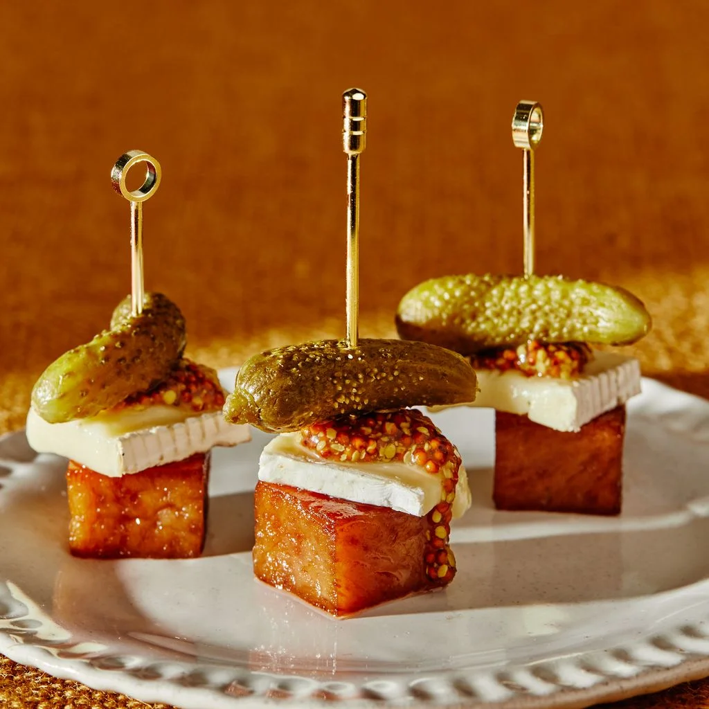 Spam and Brie bites on a white plate