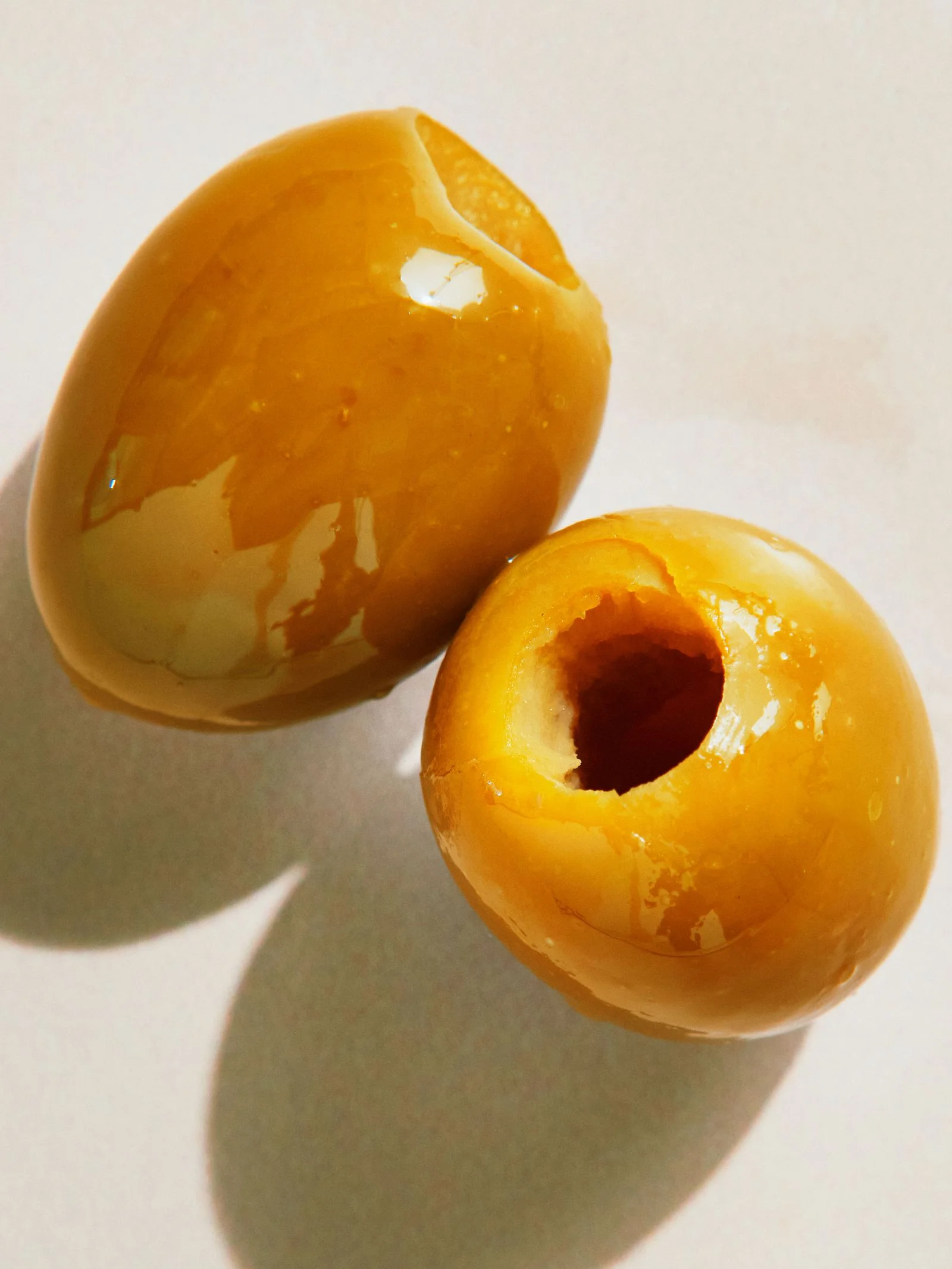 Two large pitted green Gordal olives