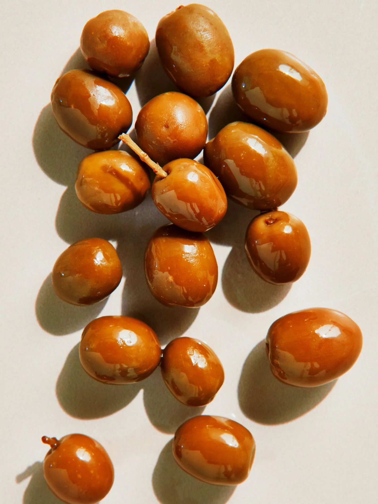 A pile of greenishtan Arbequina olives