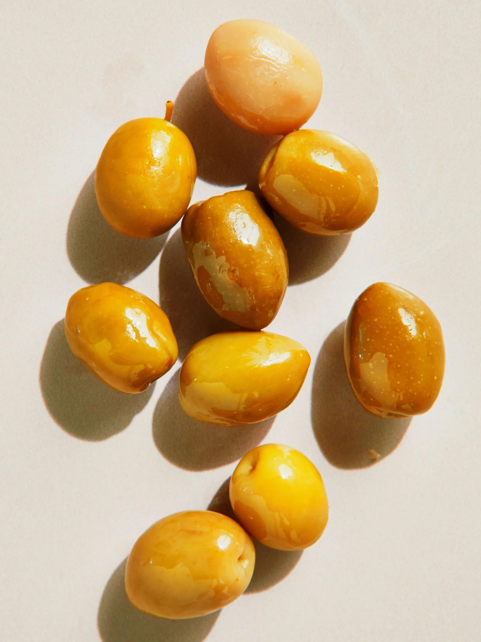 Several small yellowgreen Picholine olives.