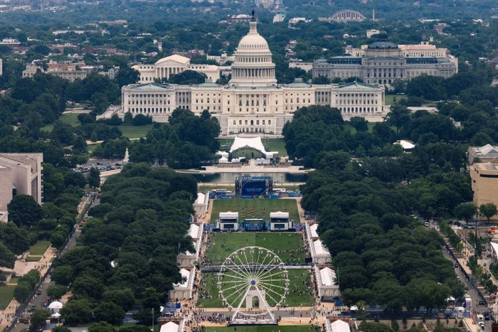 Aerial view of the National Mall in Washington, D.C., with the U.S. Capitol in the background and a Ferris wheel in the foreground