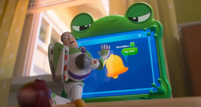Buzz Lightyear interacts with a toy tablet featuring a frog design and a message notification