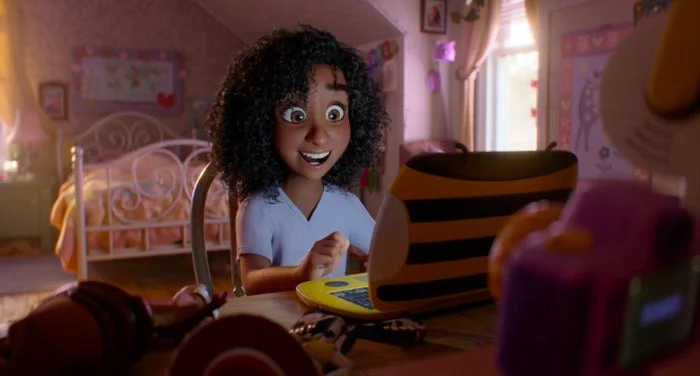 Animated character with curly hair smiles excitedly while using a laptop in a cozy bedroom setting