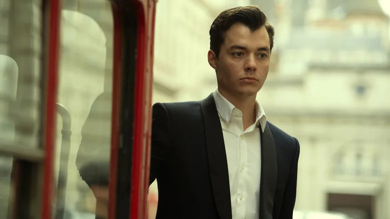Alfred Pennyworth wearing a suit and looking as sad as his future employer, Bruce Wayne