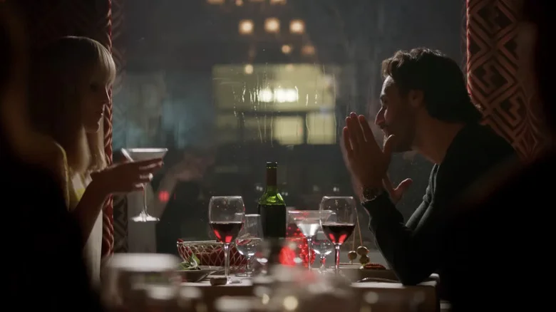 Michelle Dockery's Leticia Raines sits opposite Juan Diego Botto's Javier Pereira at a restaurant in Good Behavior