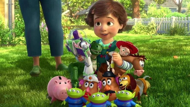 Bonnie holding all of her new toys in the yard in Toy Story 3
