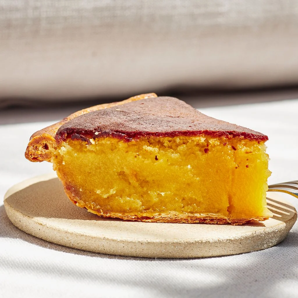 Slice of pie seen straight on with a fork on the side.