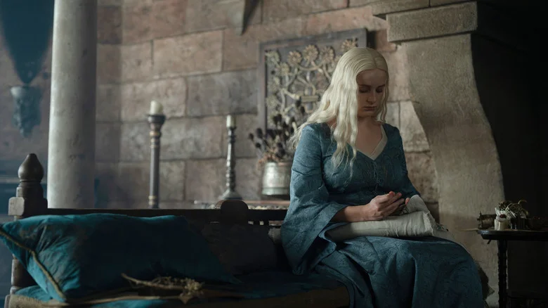 Helaena sitting on a chair stitching in House of the Dragon