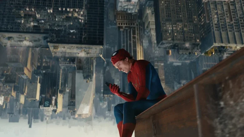 Spider-Man sitting down with upside down NYC skyline below him in Spider-Man: Brand New Day
