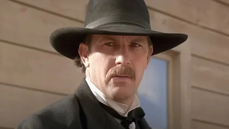 Wyatt Earp (Kevin Costner) stands in a frontier town in Wyatt Earp