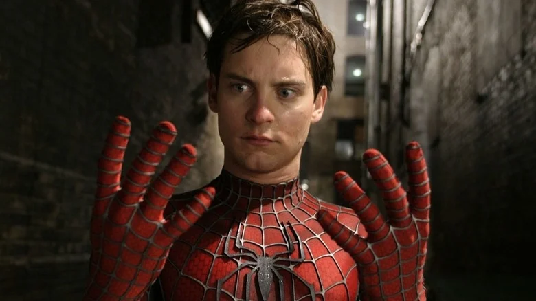 Peter staring at his hands in the Spider-Man suit in Spider-Man 2