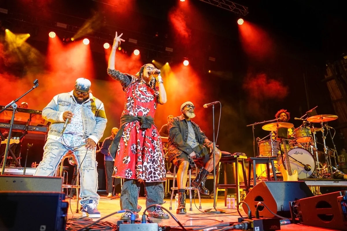 Ursula Rucker (second from left) and the Roots perform onstage during the Roots Picnic at The Mann at Fairmount Park on June 1, 2025, in Philadelphia, Pennsylvania. (Credit: Julia Beverly/WireImage)