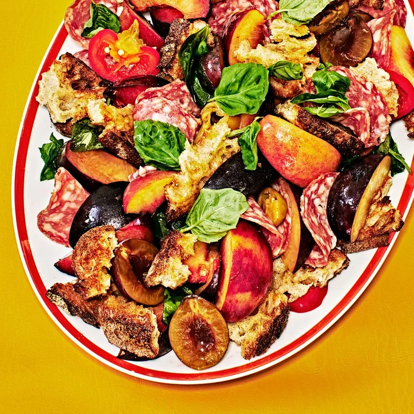 Stone Fruit and Salami Panzanella on a white plattet