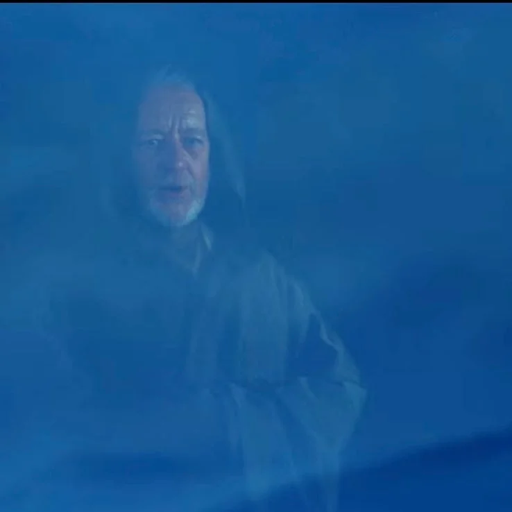 A person appears in a misty, ghostly form, wearing a hooded robe, surrounded by swirling fog