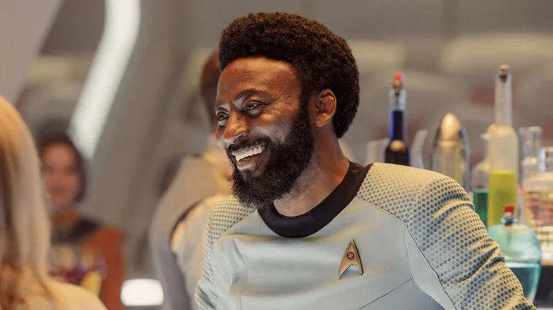 M'Benga smiling behind a bar counter in Star Trek: Strange New Worlds