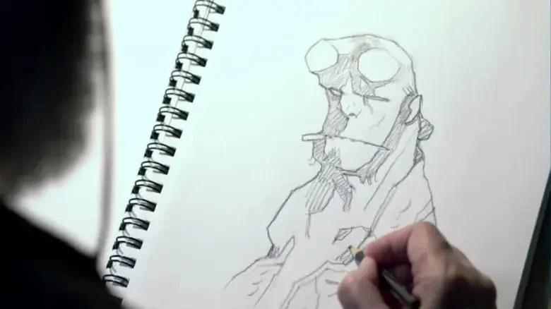 Photograph of Mike Mignola sketching Hellboy's face