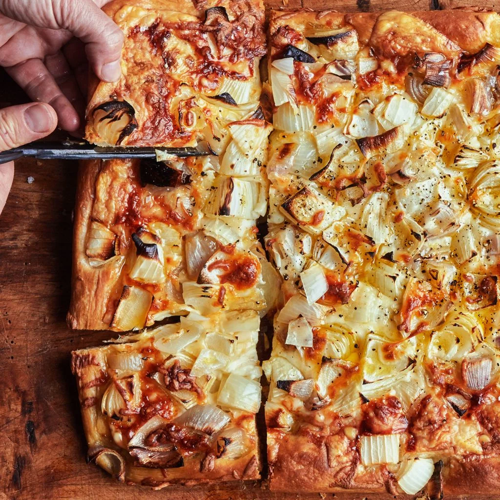 Slicing Pizza al Taglio with onion