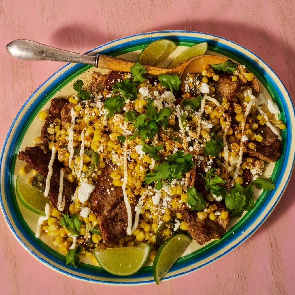 Street Corn Chicken and Pork Stir Fry plated on a green lined plate