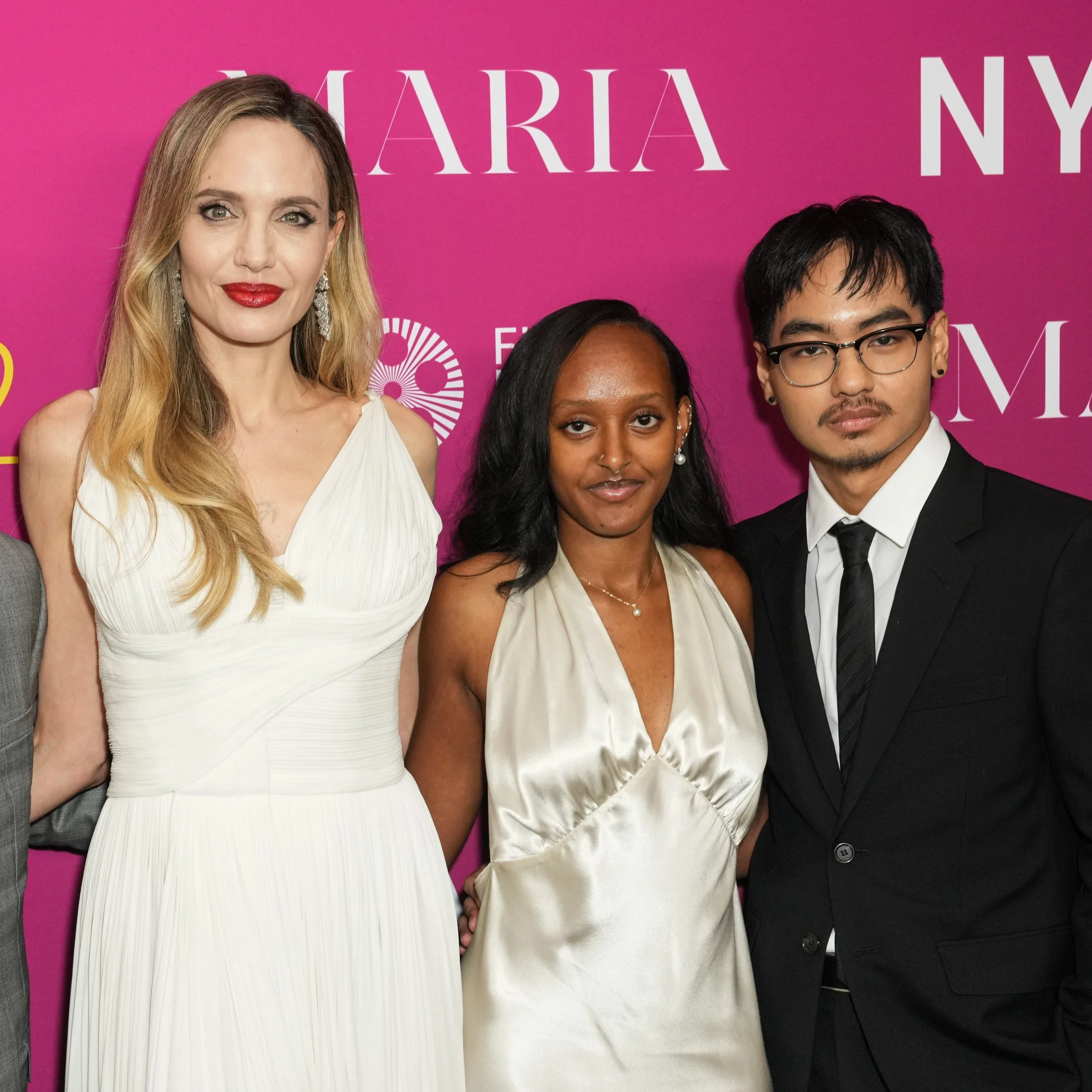 Four people pose at a NYFF event, with one wearing a white gown