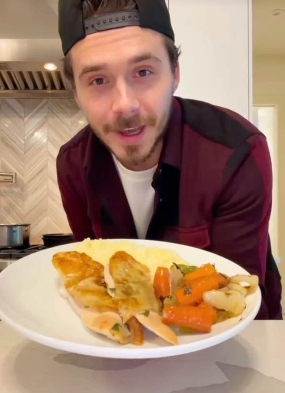 Brooklyn holding a plate of food