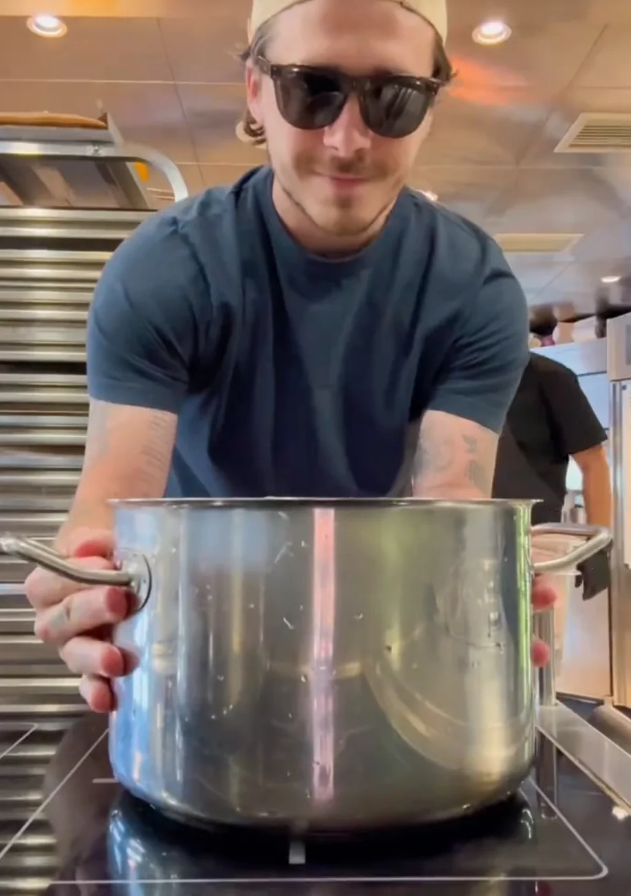 Brooklyn with a large cooking pot in a kitchen setting